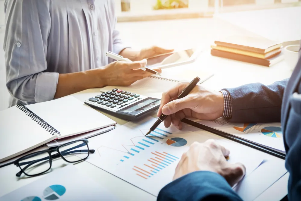 Investment documents being reviewed at a desk